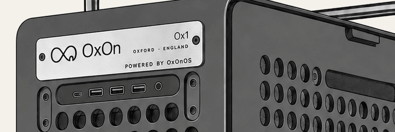 The engraved plate on the front of the Ox1, reading OxOn, Ox1, Oxford England, powered by OxOnOS, above the front ports.
